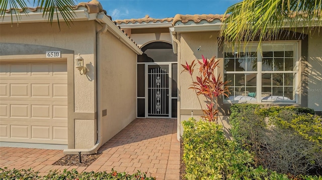 view of exterior entry featuring a garage