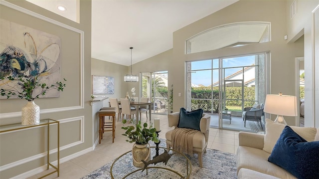 living room with light tile patterned floors and high vaulted ceiling