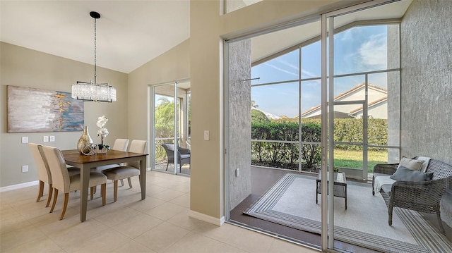 doorway to outside with light tile patterned floors, high vaulted ceiling, and a notable chandelier