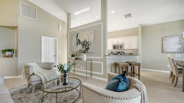 tiled living room featuring high vaulted ceiling