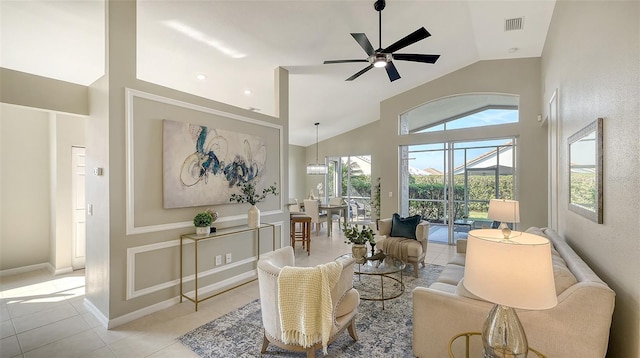 living room featuring ceiling fan, high vaulted ceiling, and light tile patterned floors