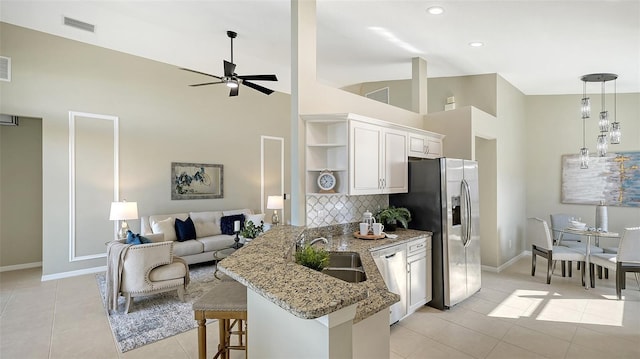 kitchen featuring appliances with stainless steel finishes, kitchen peninsula, sink, and white cabinets