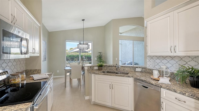 kitchen with white cabinetry, stainless steel appliances, sink, and pendant lighting