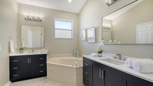 bathroom featuring a tub to relax in, vanity, vaulted ceiling, and tile patterned floors