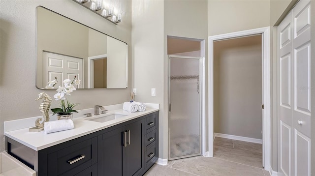 bathroom featuring vanity and an enclosed shower