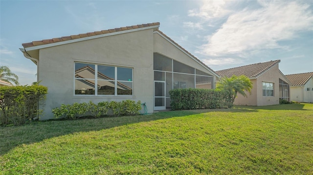 rear view of property with a lawn