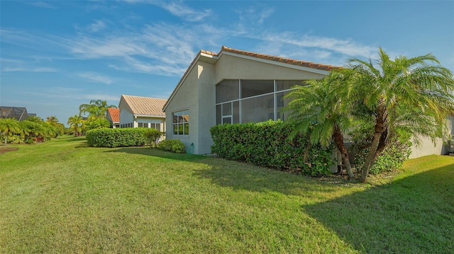 view of side of home with a yard