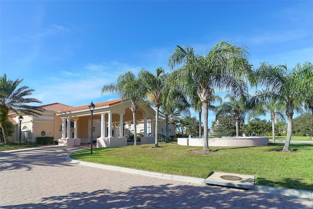 mediterranean / spanish home with a front lawn