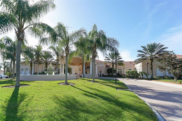 mediterranean / spanish home featuring a front lawn