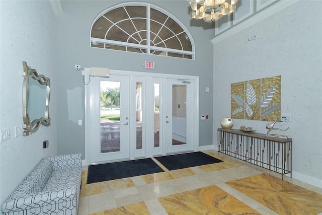 interior space featuring a towering ceiling and a notable chandelier