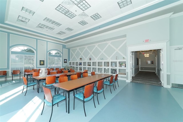 dining space featuring ornamental molding and concrete flooring