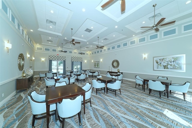 dining space with coffered ceiling, carpet floors, a towering ceiling, and ceiling fan