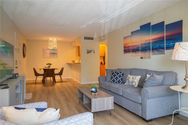 living room featuring a textured ceiling and hardwood / wood-style floors