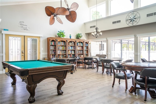 playroom featuring a towering ceiling, wood-type flooring, french doors, billiards, and ceiling fan