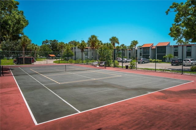 view of tennis court featuring basketball hoop