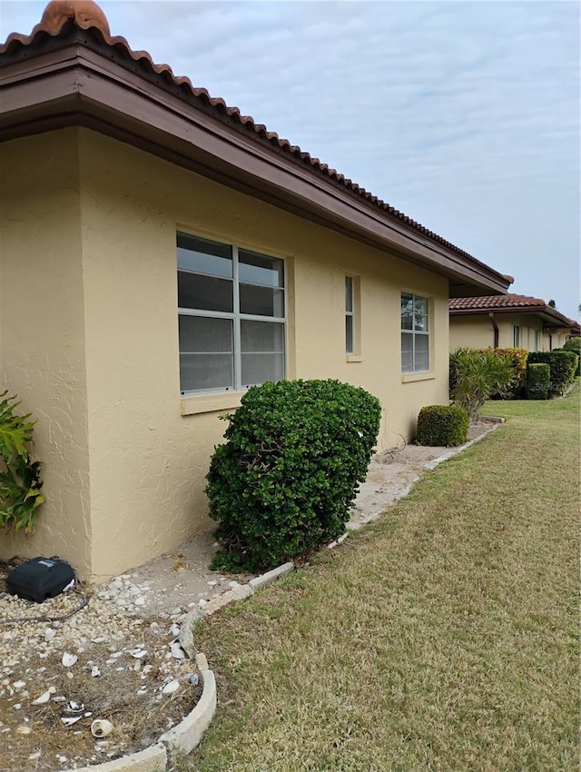 view of side of home featuring a yard