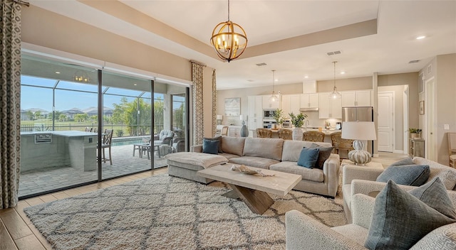 living room with a notable chandelier and light hardwood / wood-style floors