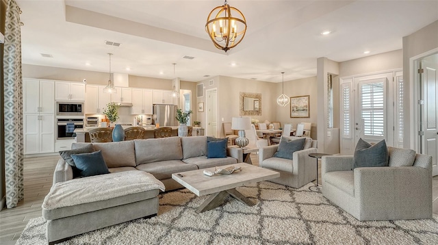 living room featuring a notable chandelier