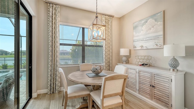 dining space featuring a water view and a chandelier