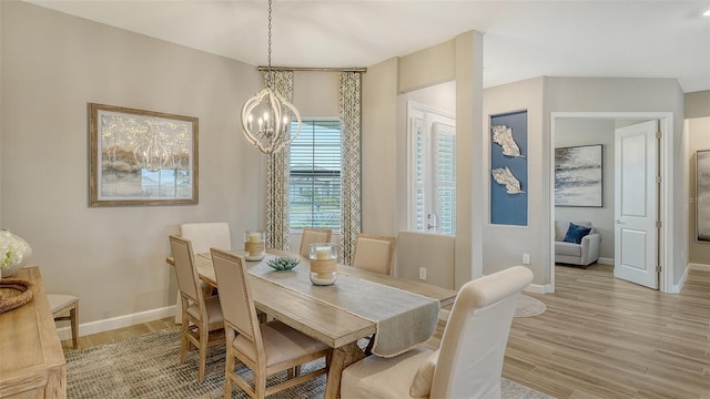 dining area with a chandelier and light hardwood / wood-style floors