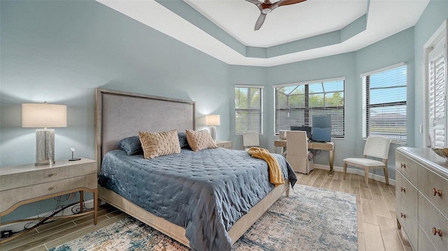 bedroom featuring ceiling fan and a tray ceiling