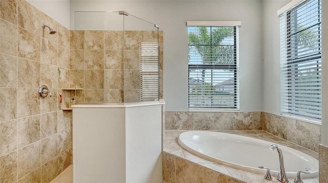 bathroom featuring shower with separate bathtub