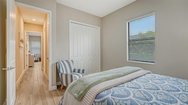 bedroom featuring light wood-type flooring and a closet