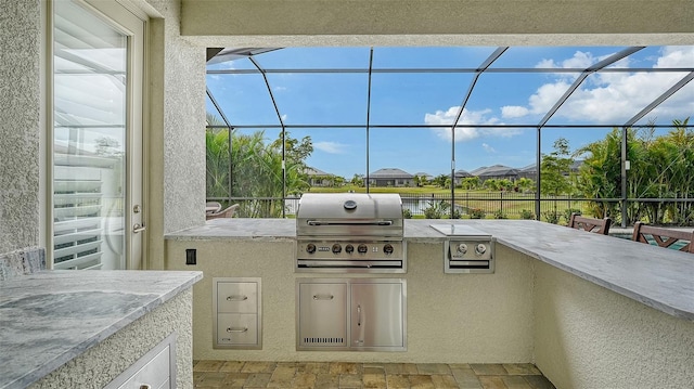 view of patio / terrace featuring a lanai, a grill, and area for grilling