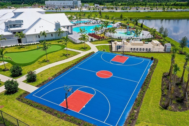 view of sport court with a lawn, a community pool, and a water view