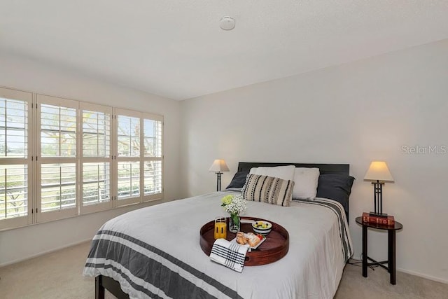 carpeted bedroom with baseboards