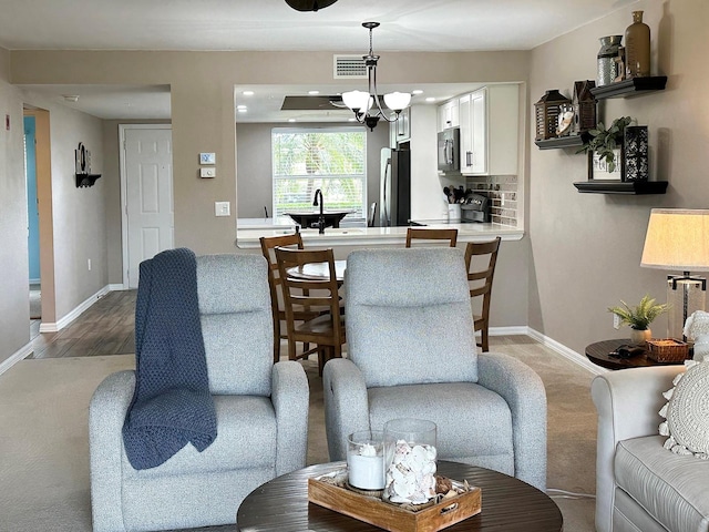 living room featuring an inviting chandelier and sink