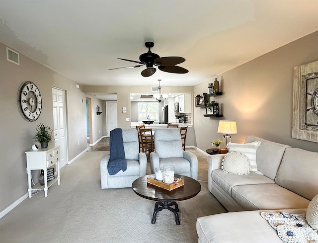 carpeted living room featuring ceiling fan