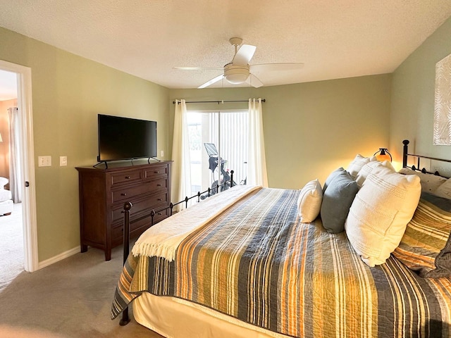 bedroom with ceiling fan, a textured ceiling, and carpet flooring