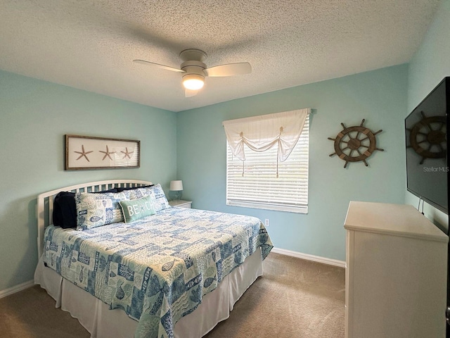 carpeted bedroom with ceiling fan and a textured ceiling