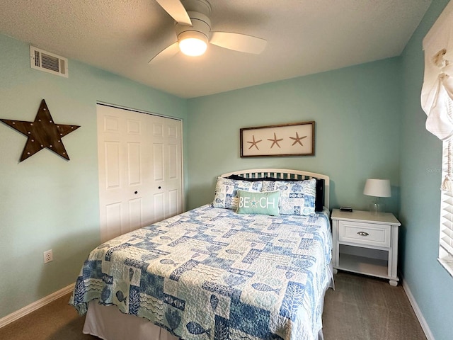 carpeted bedroom featuring a closet and ceiling fan