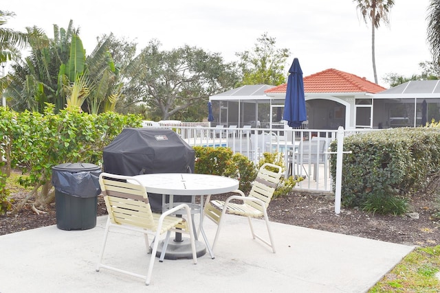 view of patio featuring a lanai, a sunroom, a swimming pool, and area for grilling