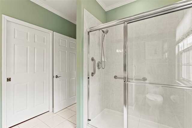 bathroom featuring crown molding, tile patterned floors, and an enclosed shower