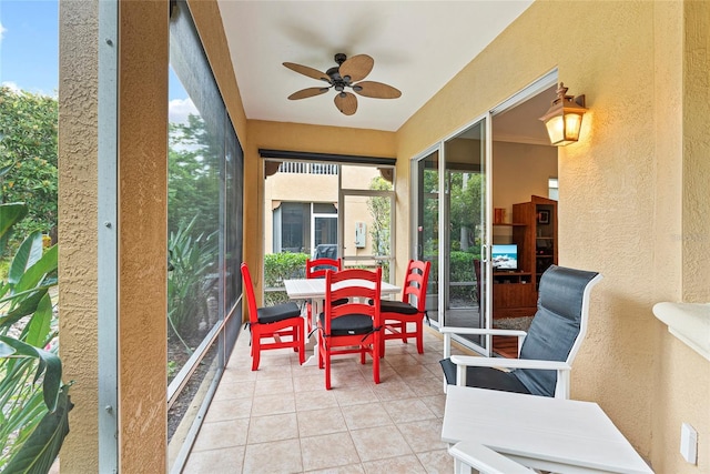 sunroom / solarium featuring ceiling fan