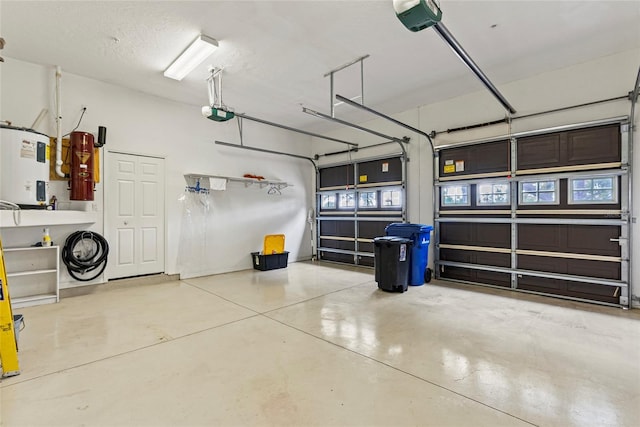 garage with electric water heater and a garage door opener