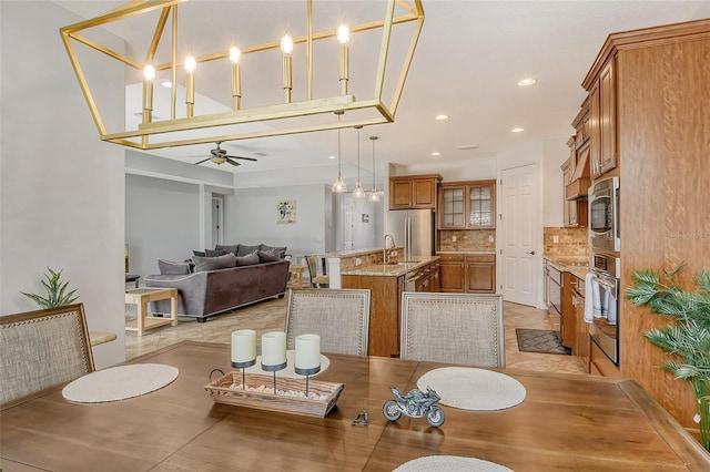 dining room with ceiling fan and sink