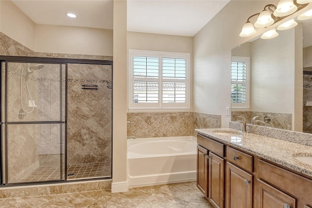 bathroom featuring tile patterned floors, vanity, and separate shower and tub