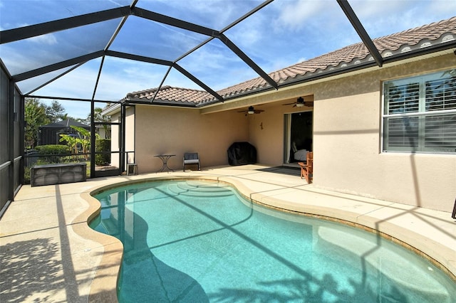 view of swimming pool featuring a patio, a lanai, and ceiling fan