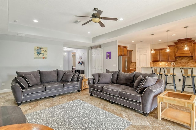 living room featuring sink and ceiling fan