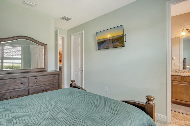 carpeted bedroom with ensuite bathroom