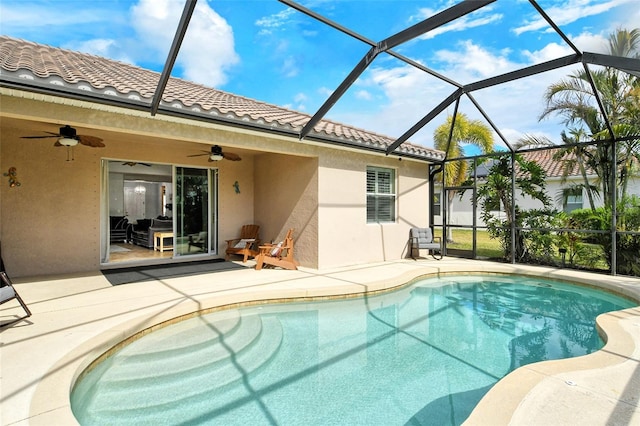 view of pool featuring a patio area, ceiling fan, and glass enclosure