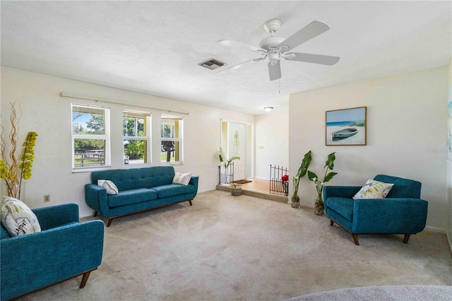 living room with ceiling fan and light colored carpet