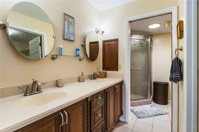 bathroom with a shower with shower door, vanity, and tile patterned floors