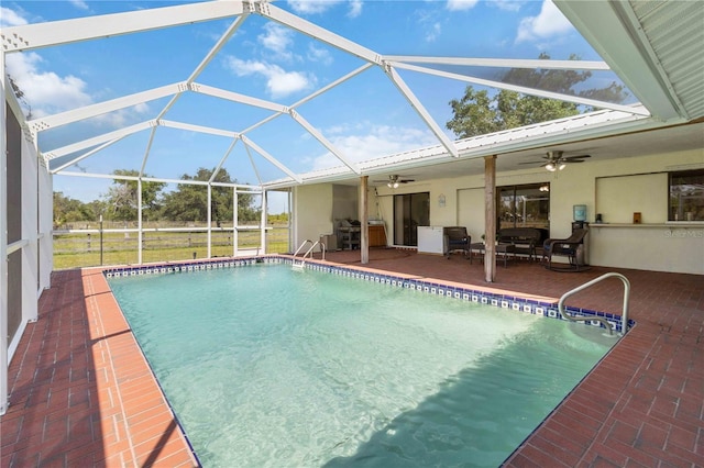 view of pool with a lanai, ceiling fan, and a patio