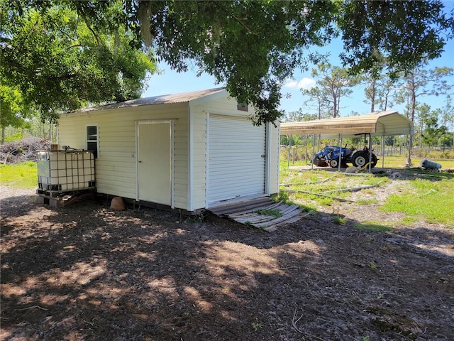 view of outdoor structure featuring a garage and a carport