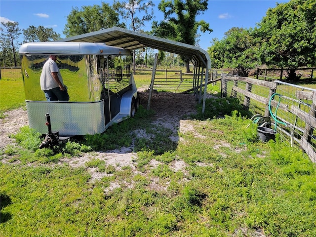 view of yard featuring a rural view and a carport